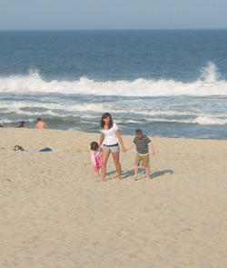 a woman and her child on the beach